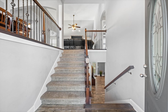 2263 Allen Griffey Ct, Clarksville, TN 37042 - foyer featuring a ceiling fan, baseboards, stairs, wood finished floors, and arched walkways