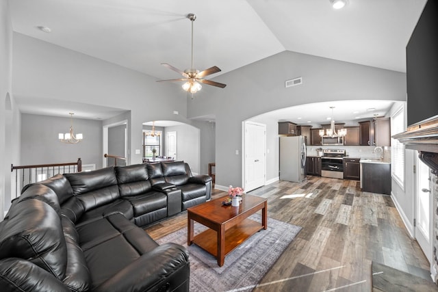 2263 Allen Griffey Ct, Clarksville, TN 37042 - living area with ceiling fan with notable chandelier, wood finished floors, visible vents, recessed lighting, and arched walkways
