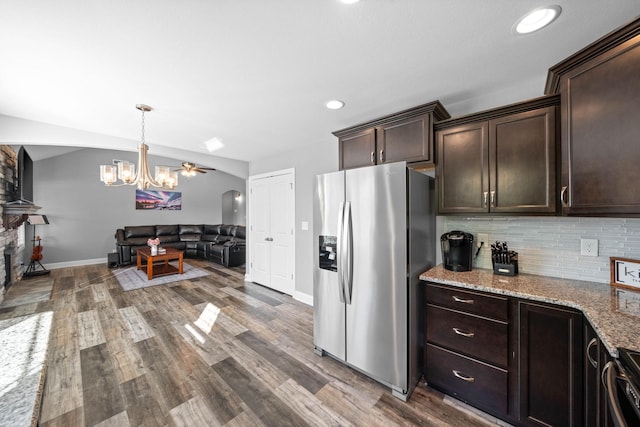 2263 Allen Griffey Ct, Clarksville, TN 37042 - kitchen featuring light stone counters, backsplash, stainless steel refrigerator with ice dispenser, and dark brown cabinets