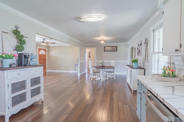 kitchen with white cabinetry, crown molding, dark wood-style flooring, a textured ceiling, and dishwasher