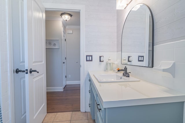 bathroom with tile patterned flooring, vanity, and ornamental molding