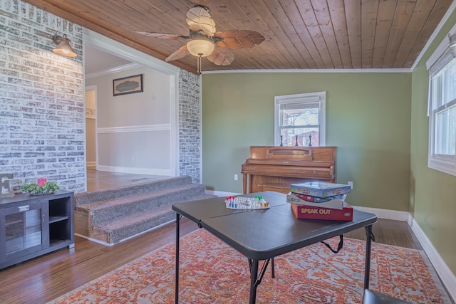 living area with wooden ceiling, crown molding, ceiling fan, and wood finished floors