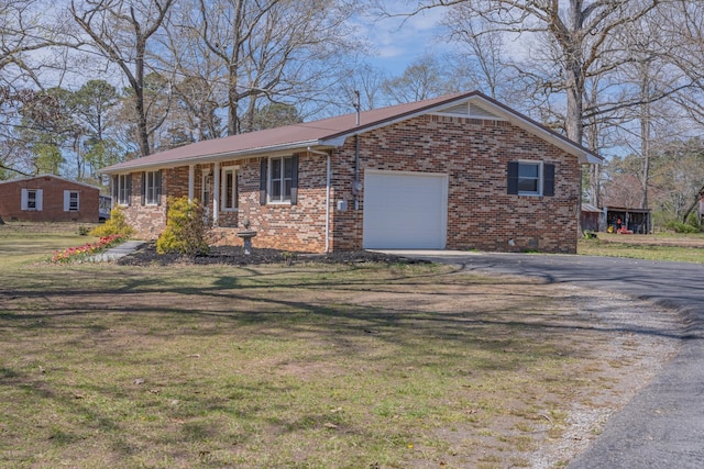 ranch-style house featuring aphalt driveway, metal roof, brick siding, and a front yard