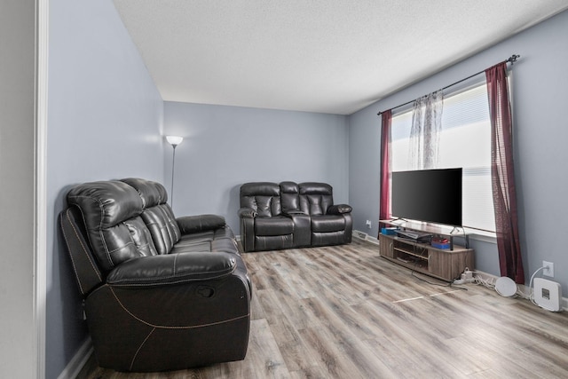 1571 Barrett Dr, Clarksville, TN 37043 - living area featuring a textured ceiling, baseboards, and wood finished floors