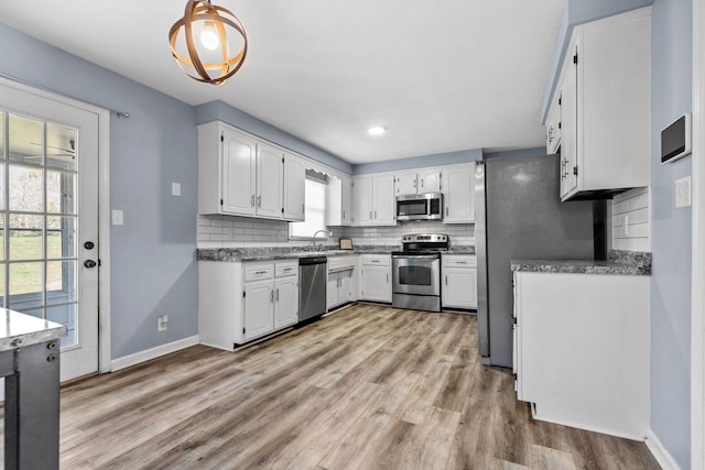 1571 Barrett Dr, Clarksville, TN 37043 - kitchen with white cabinetry, a sink, and stainless steel appliances
