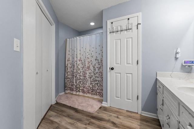 1571 Barrett Dr, Clarksville, TN 37043 - bathroom with baseboards, a shower with shower curtain, wood finished floors, and vanity