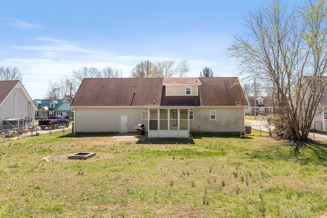 1571 Barrett Dr, Clarksville, TN 37043 - back of house with a lawn, a sunroom, fence, and a fire pit