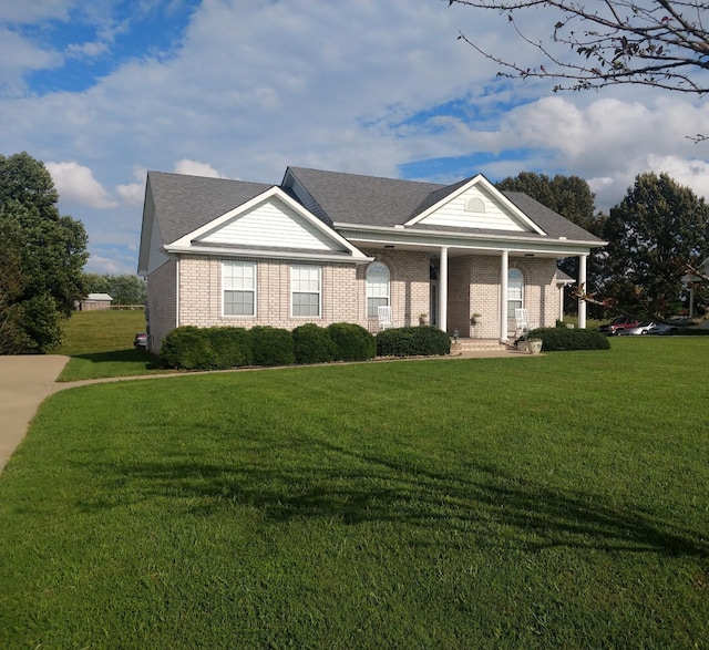 106 Mai Ridge Ln, Lafayette, TN 37083 - neoclassical / greek revival house with a front lawn, covered porch, brick siding, and a shingled roof