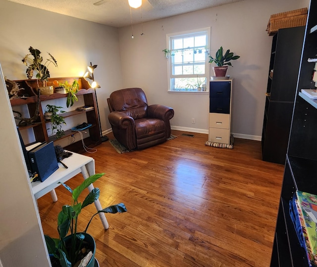 139 Hillcrest Cir, Gordonsville, TN 38563 - living area featuring a ceiling fan, wood finished floors, a textured ceiling, baseboards, and visible vents