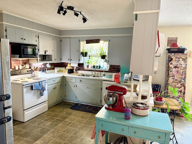 139 Hillcrest Cir, Gordonsville, TN 38563 - kitchen featuring a sink, freestanding refrigerator, black microwave, a textured ceiling, and electric stove