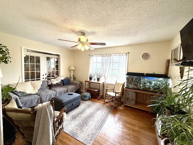 139 Hillcrest Cir, Gordonsville, TN 38563 - living room with wood finished floors, ceiling fan, french doors, and a textured ceiling