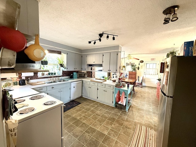 139 Hillcrest Cir, Gordonsville, TN 38563 - kitchen featuring light countertops, rail lighting, white appliances, a textured ceiling, and a sink