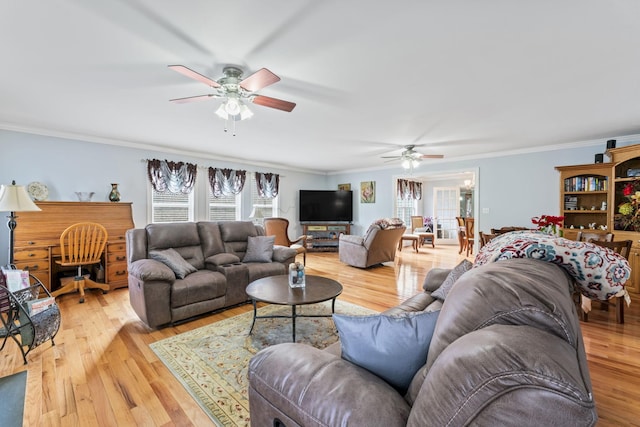 living room featuring wood finished floors, ceiling fan, and ornamental molding