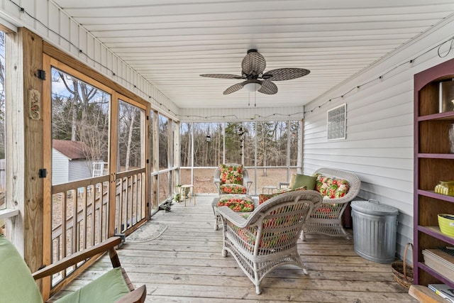 sunroom featuring a ceiling fan
