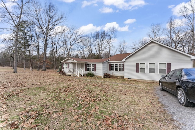 single story home featuring covered porch, crawl space, and a shingled roof