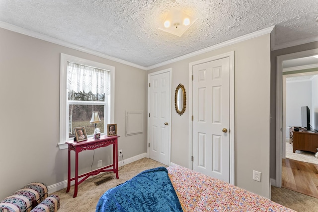 bedroom with light colored carpet, visible vents, ornamental molding, and a textured ceiling