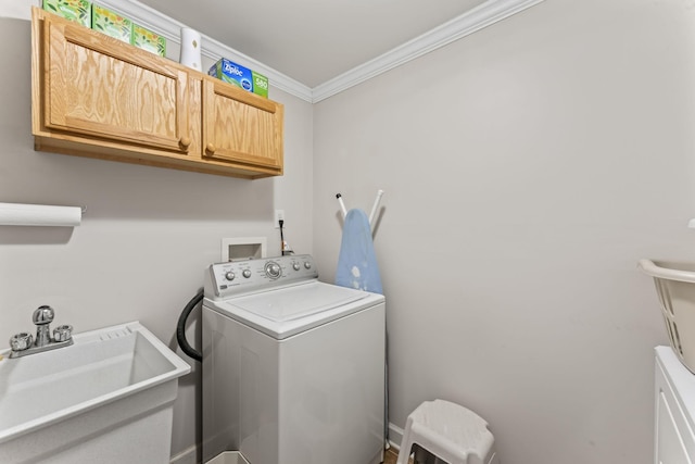 laundry area with cabinet space, washer / clothes dryer, a sink, and crown molding