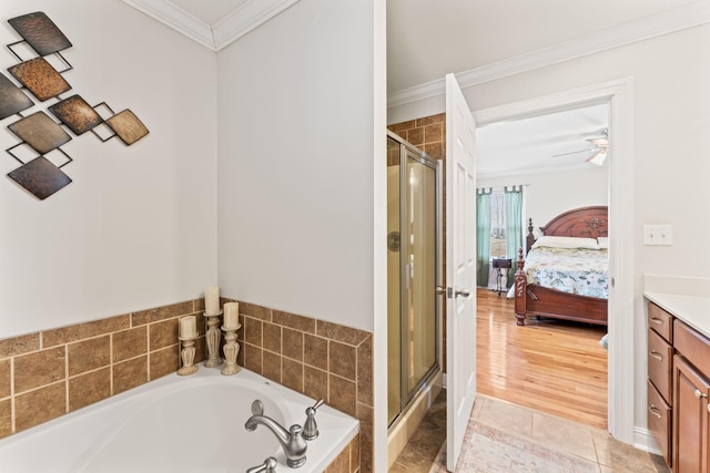 ensuite bathroom with a bath, a shower stall, connected bathroom, ornamental molding, and vanity
