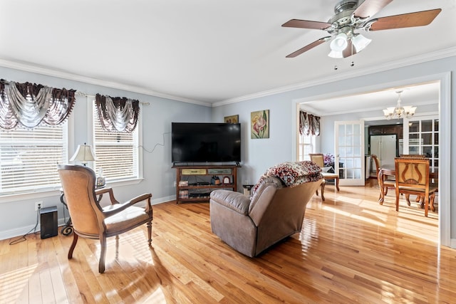 living area with baseboards, light wood-type flooring, and ornamental molding