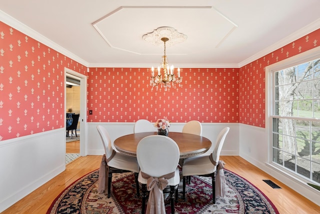 409 Cunniff Pkwy, Goodlettsville, TN 37072 - dining area with wallpapered walls, visible vents, light wood-style flooring, a notable chandelier, and wainscoting
