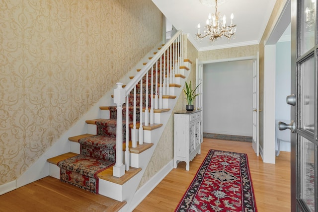 409 Cunniff Pkwy, Goodlettsville, TN 37072 - foyer entrance featuring wallpapered walls, ornamental molding, stairway, and wood finished floors
