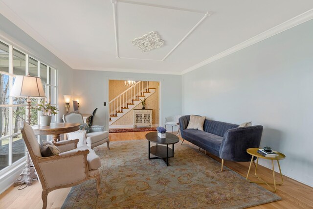 409 Cunniff Pkwy, Goodlettsville, TN 37072 - living room featuring wood finished floors, a chandelier, stairway, and crown molding