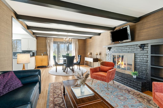 409 Cunniff Pkwy, Goodlettsville, TN 37072 - living area with an inviting chandelier, beam ceiling, light wood-style floors, and a fireplace