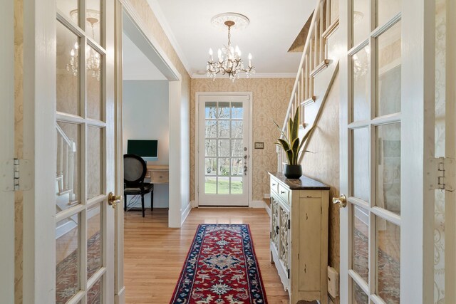 409 Cunniff Pkwy, Goodlettsville, TN 37072 - foyer entrance featuring crown molding, an inviting chandelier, french doors, wallpapered walls, and light wood-style floors