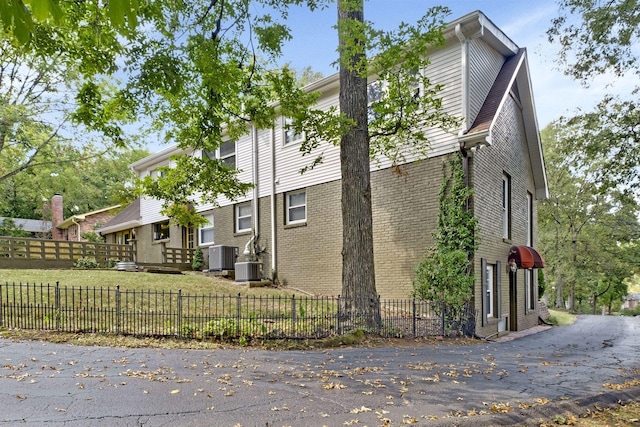 409 Cunniff Pkwy, Goodlettsville, TN 37072 - view of property exterior featuring a lawn, brick siding, a fenced front yard, and cooling unit