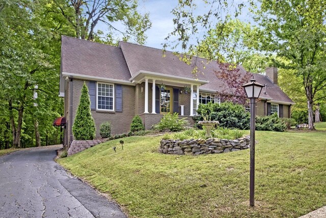 409 Cunniff Pkwy, Goodlettsville, TN 37072 - view of front of property with a chimney, brick siding, aphalt driveway, and a front lawn