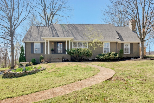 409 Cunniff Pkwy, Goodlettsville, TN 37072 - view of front of home with a shingled roof, a chimney, a front yard, and brick siding