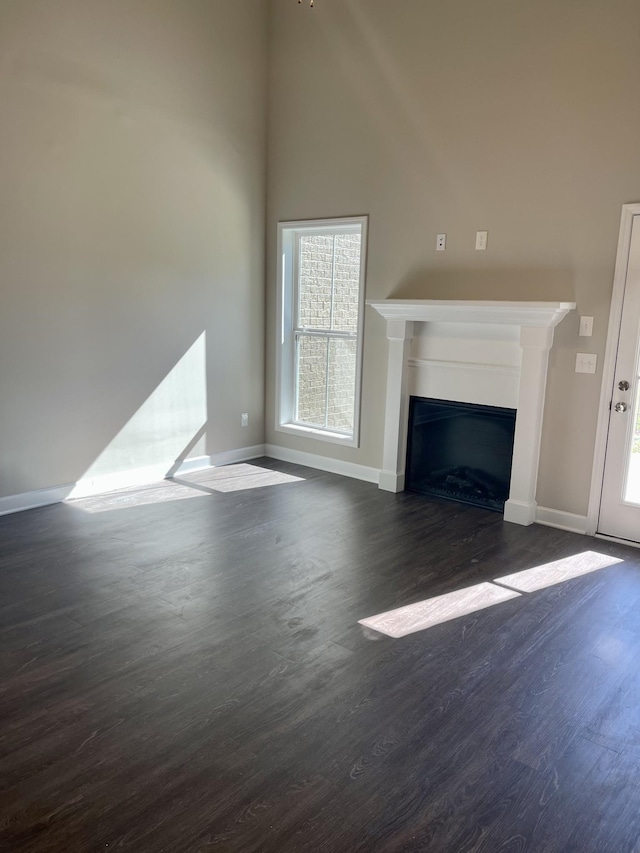 967 Horse Mountain Rd Unit 6G, Shelbyville, TN 37160 - unfurnished living room featuring dark wood-type flooring, baseboards, and a fireplace