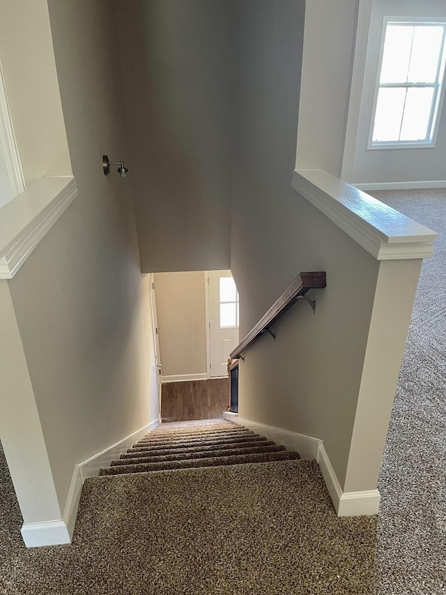 stairs with baseboards and a towering ceiling