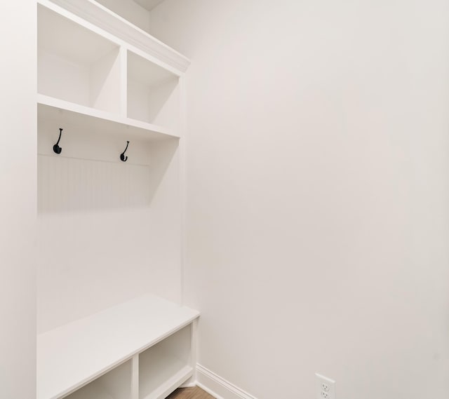 mudroom with baseboards and wood finished floors