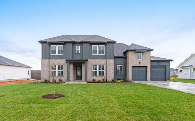view of front facade with an attached garage, board and batten siding, brick siding, a front lawn, and driveway