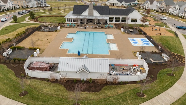 view of swimming pool with a patio area, a residential view, and fence