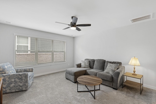 carpeted living room with baseboards, ceiling fan, and visible vents