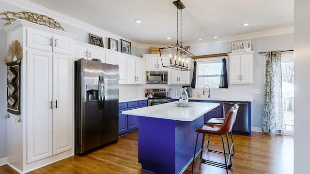 510 Castleview Dr, Lebanon, TN 37087 - kitchen featuring blue cabinetry, light countertops, white cabinetry, and appliances with stainless steel finishes