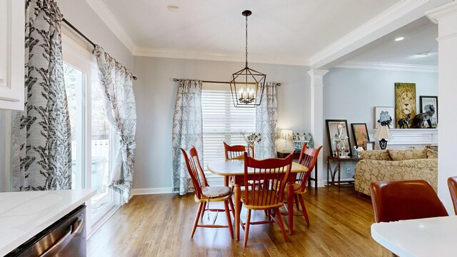 510 Castleview Dr, Lebanon, TN 37087 - dining area featuring light wood finished floors, decorative columns, ornamental molding, and an inviting chandelier