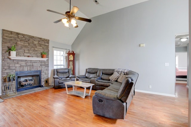 4425 Taylor Hall Ln, Adams, TN 37010 - living room with high vaulted ceiling, baseboards, ceiling fan, a fireplace, and light wood-style floors
