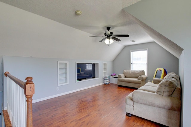 4425 Taylor Hall Ln, Adams, TN 37010 - living area featuring vaulted ceiling, baseboards, a textured ceiling, built in features, and wood finished floors