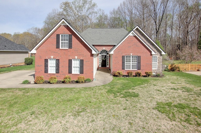 4425 Taylor Hall Ln, Adams, TN 37010 - view of front of house featuring brick siding, fence, and a front lawn