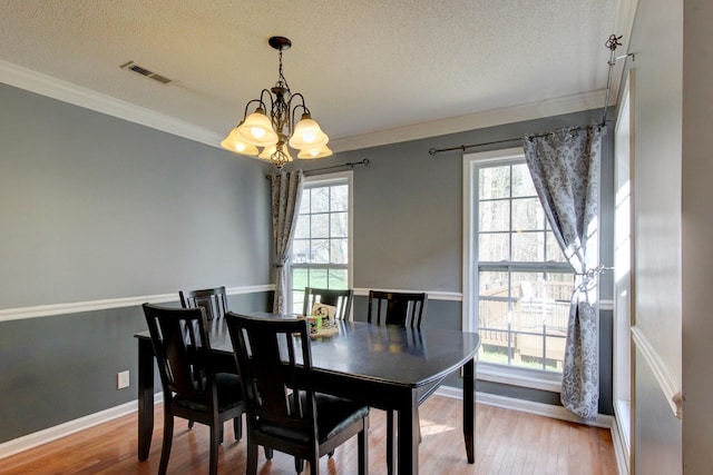 4425 Taylor Hall Ln, Adams, TN 37010 - dining room with ornamental molding, visible vents, a notable chandelier, and wood finished floors