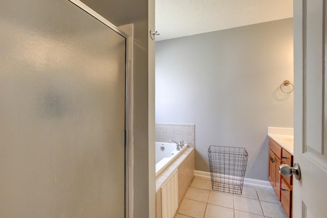 4425 Taylor Hall Ln, Adams, TN 37010 - full bath featuring baseboards, tile patterned floors, vanity, a stall shower, and a garden tub