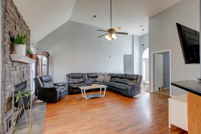4425 Taylor Hall Ln, Adams, TN 37010 - living room with high vaulted ceiling, a large fireplace, light wood-style flooring, visible vents, and ceiling fan