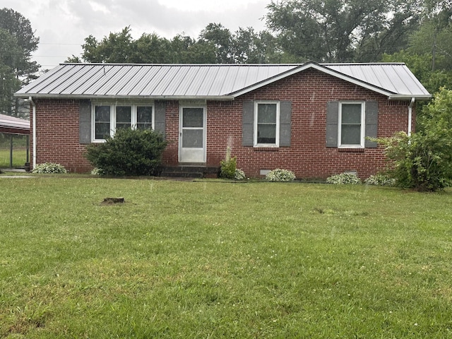 311 Thomas St, Lawrenceburg, TN 38464 - ranch-style home featuring a front yard, brick siding, metal roof, and entry steps