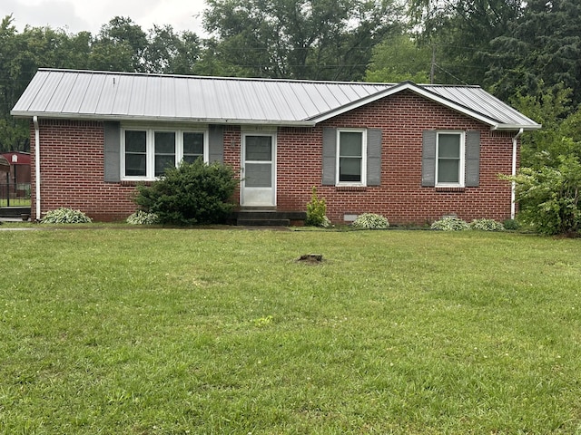 311 Thomas St, Lawrenceburg, TN 38464 - single story home with brick siding, a front yard, metal roof, and entry steps