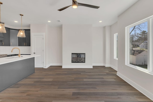 1016 W Kirkland Ave Unit F, Nashville, TN 37216 - unfurnished living room featuring a sink, a ceiling fan, baseboards, visible vents, and dark wood-style flooring