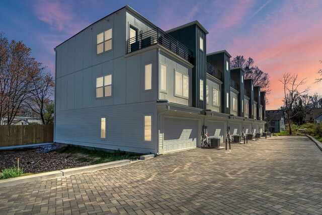 1016 W Kirkland Ave Unit E, Nashville, TN 37216 - view of side of property with a balcony, central air condition unit, fence, a garage, and driveway