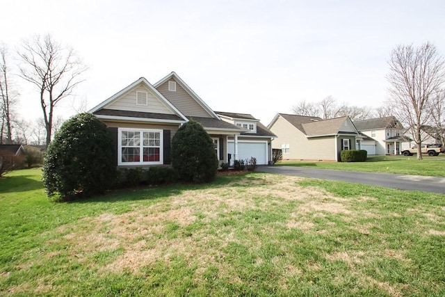 view of front of property with driveway, an attached garage, and a front lawn